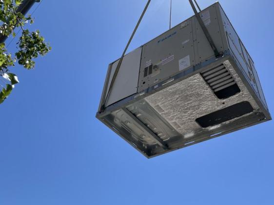 Image of a crane lifting a roof top unit for CLR
